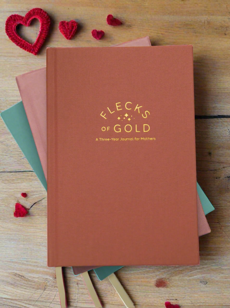 Flecks of Gold Journals with gold embossing. A Three-Year Journal For Mothers. Helping you find the joy in Motherhood. A journal for moms who want to see the good in every day. Helping overwhelmed, busy moms. Created by Rachel Nielson of 3 in 30 Podcast. Motherhood Journal.  Gratitude Journal.