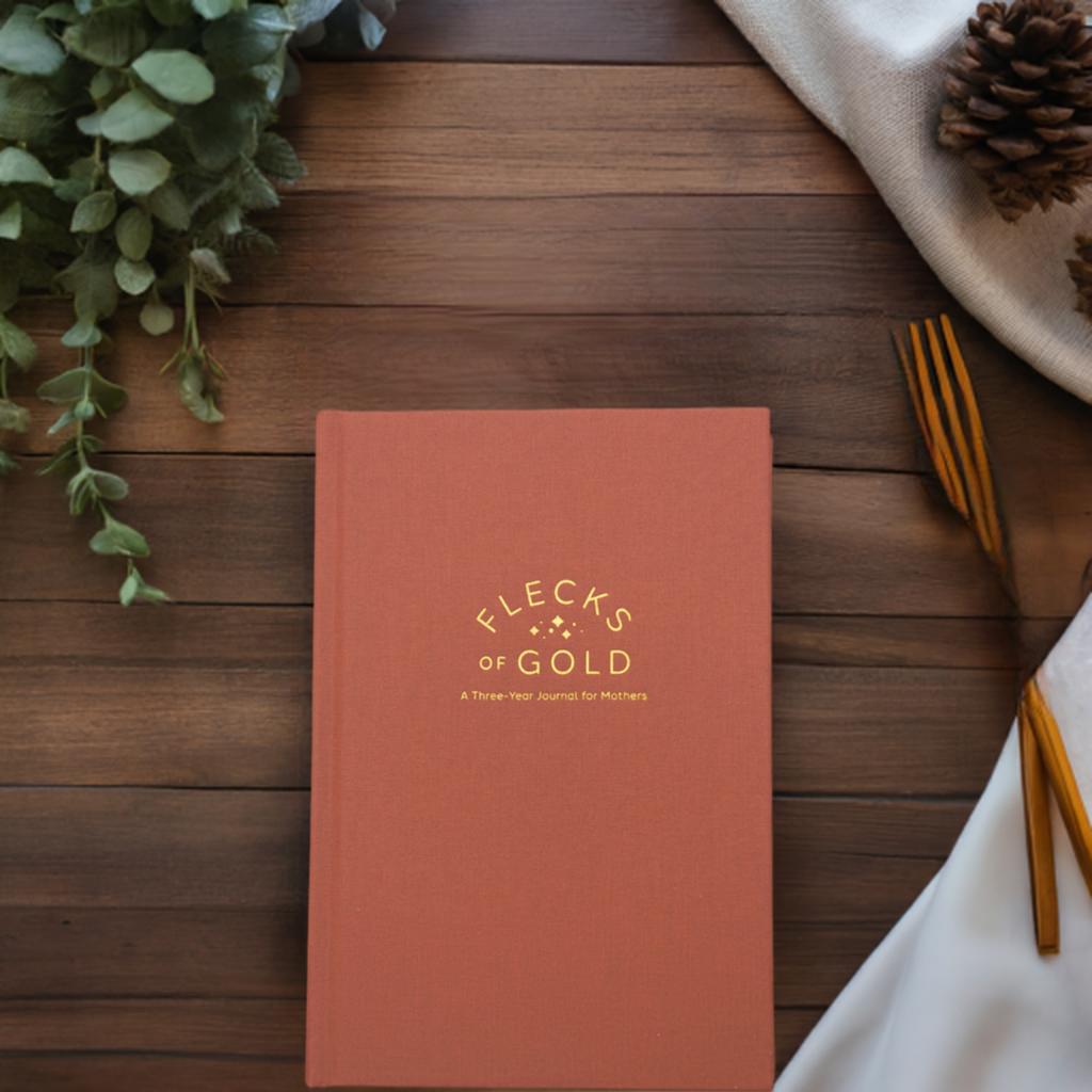 Teracotta Linen Flecks of Gold Journal with gold embossing. A Three-Year Journal For Mothers. Helping you find the joy in Motherhood. A journal for moms who want to see the good in every day. Helping overwhelmed, busy moms. Created by Rachel Nielson of 3 in 30 Podcast. Motherhood Journal.  Gratitude Journal.