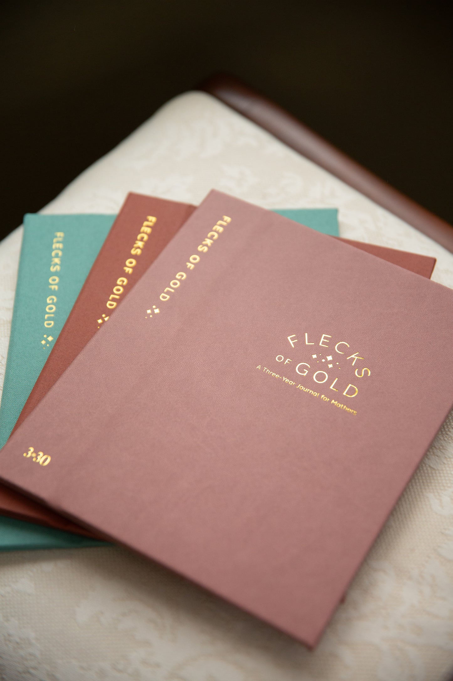 Flecks of Gold Journal with gold embossing. A Three-Year Journal For Mothers. Helping you find the joy in Motherhood. A journal for moms who want to see the good in every day. Helping overwhelmed, busy moms. Created by Rachel Nielson of 3 in 30 Podcast. Motherhood Journal.  Gratitude Journal.