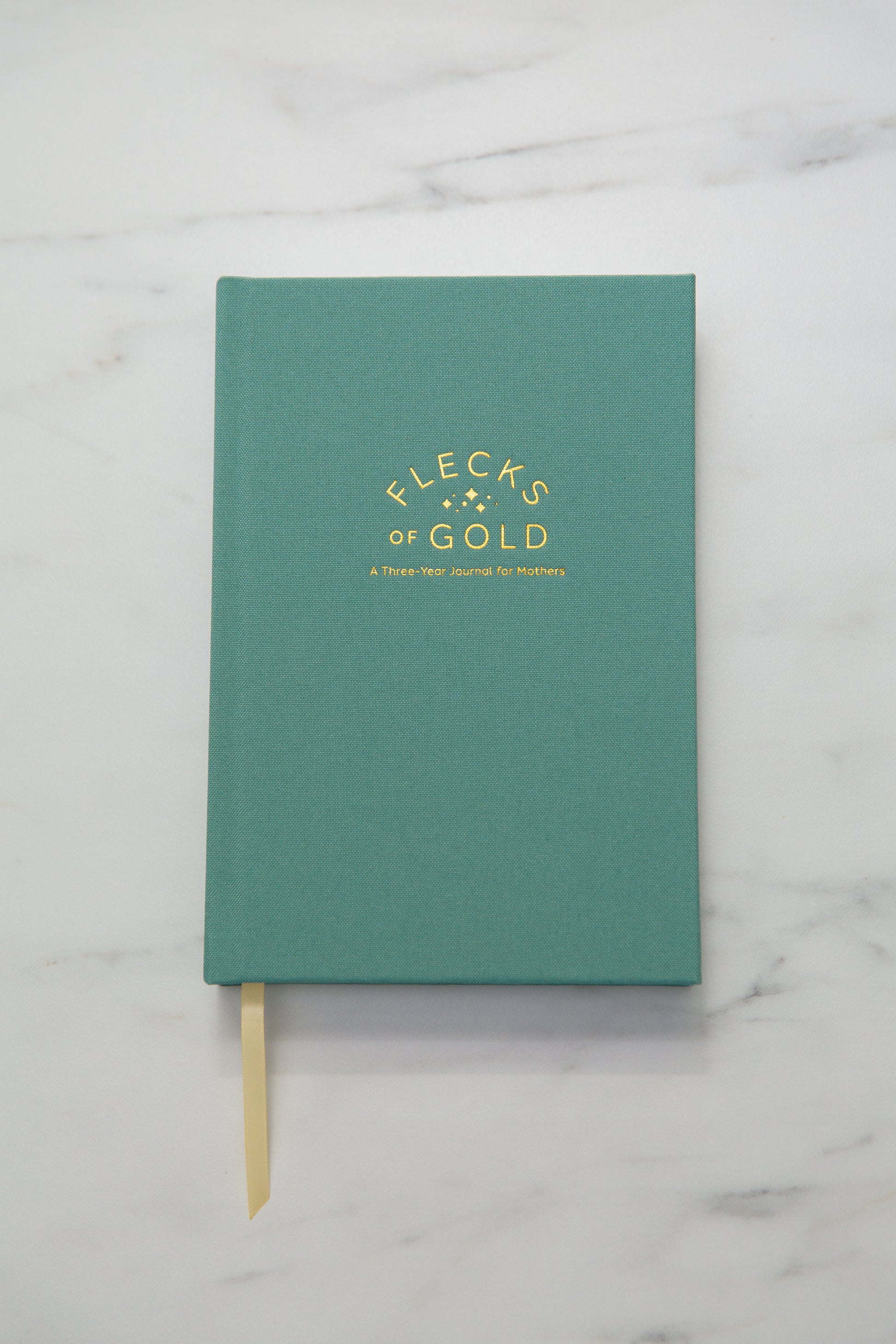Teal Linen Flecks of Gold Journal with gold embossing. A Three-Year Journal For Mothers. Helping you find the joy in Motherhood. A journal for moms who want to see the good in every day. Helping overwhelmed, busy moms. Created by Rachel Nielson of 3 in 30 Podcast. Motherhood Journal.  Gratitude Journal.
