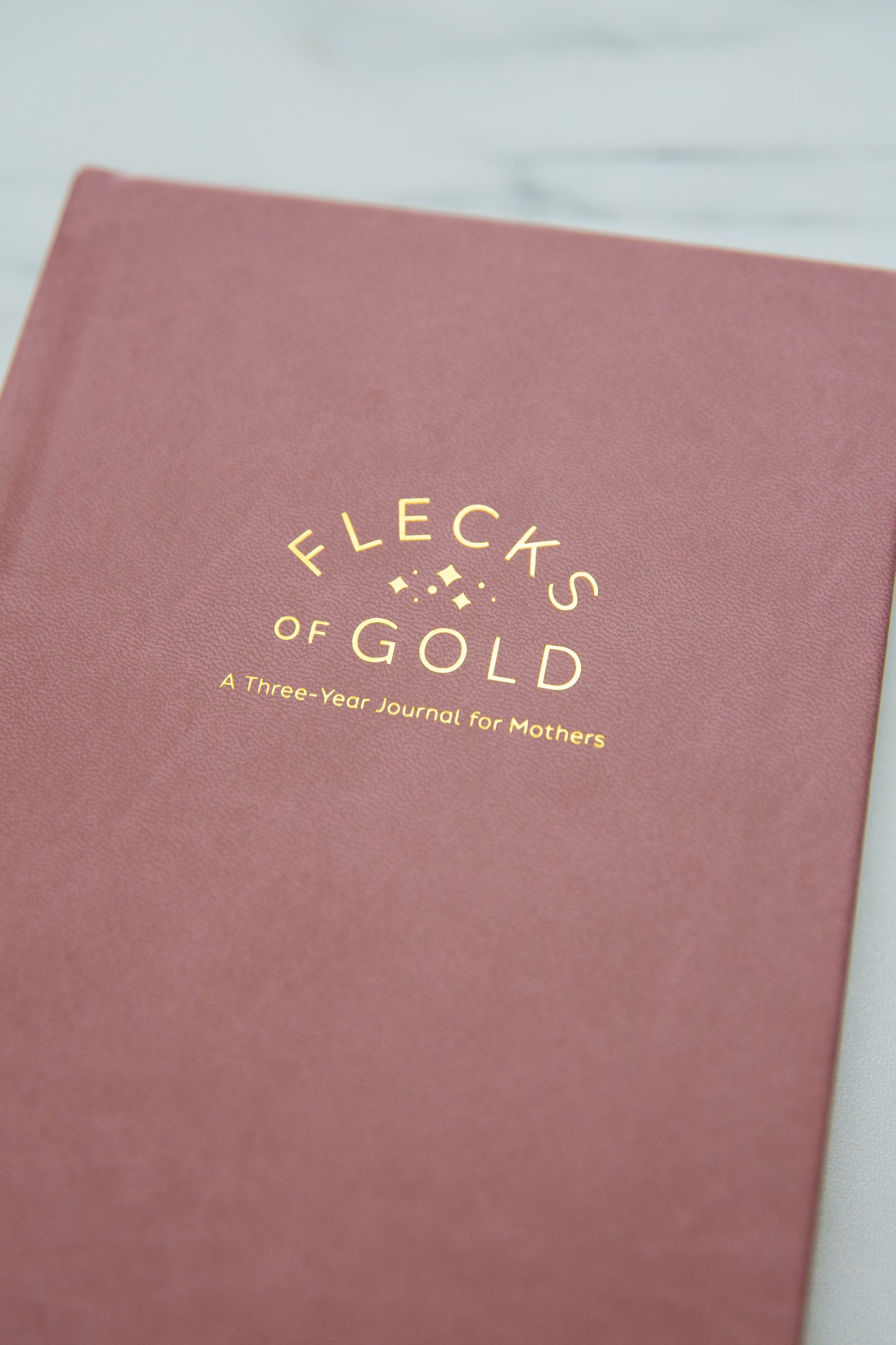 Vegan Rose Flecks of Gold Journal with gold embossing. A Three-Year Journal For Mothers. Helping you find the joy in Motherhood. A journal for moms who want to see the good in every day. Helping overwhelmed, busy moms. Created by Rachel Nielson of 3 in 30 Podcast. Motherhood Journal. Gratitude Journal.