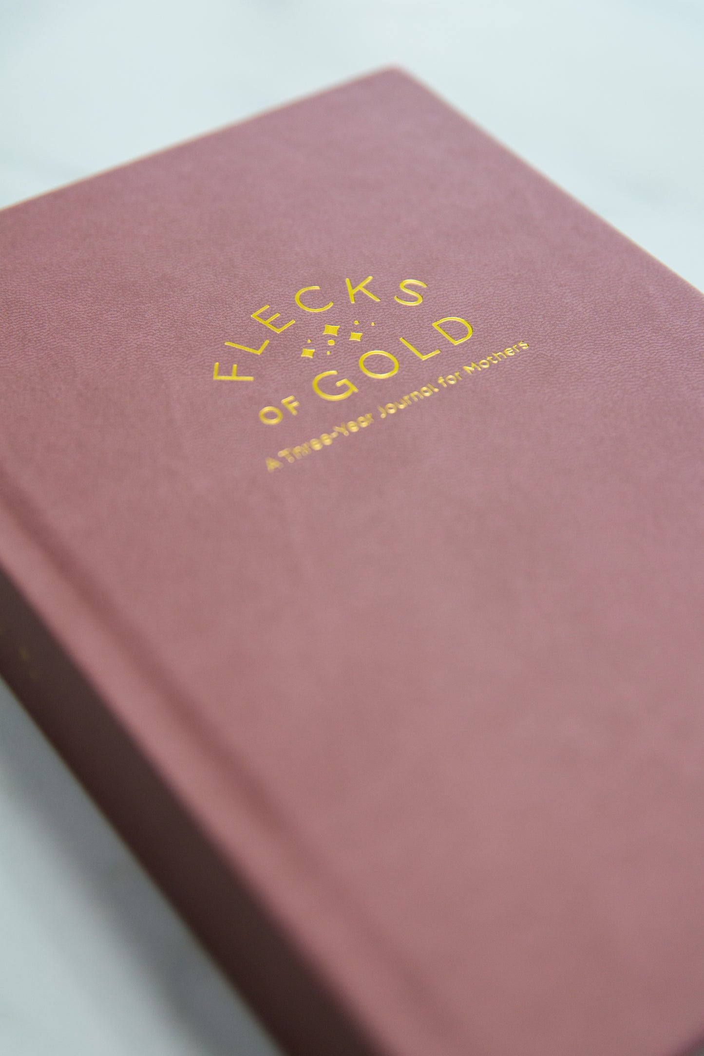 Vegan Rose Flecks of Gold Journal with gold embossing. A Three-Year Journal For Mothers. Helping you find the joy in Motherhood. A journal for moms who want to see the good in every day. Helping overwhelmed, busy moms. Created by Rachel Nielson of 3 in 30 Podcast. Motherhood Journal. Gratitude Journal.