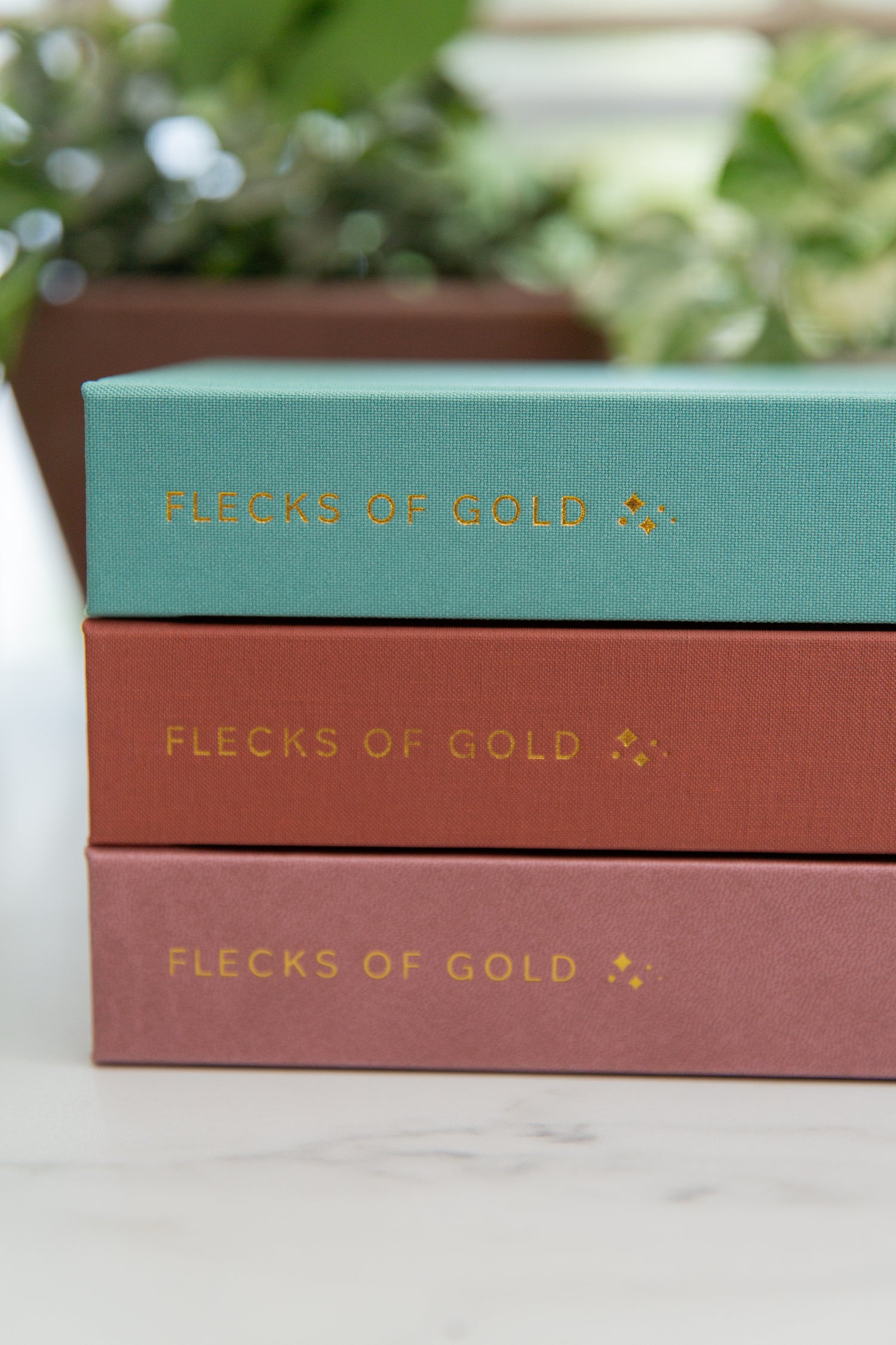 "Gold-embossed Flecks of Gold Journals – a three-year gratitude journal for busy moms."