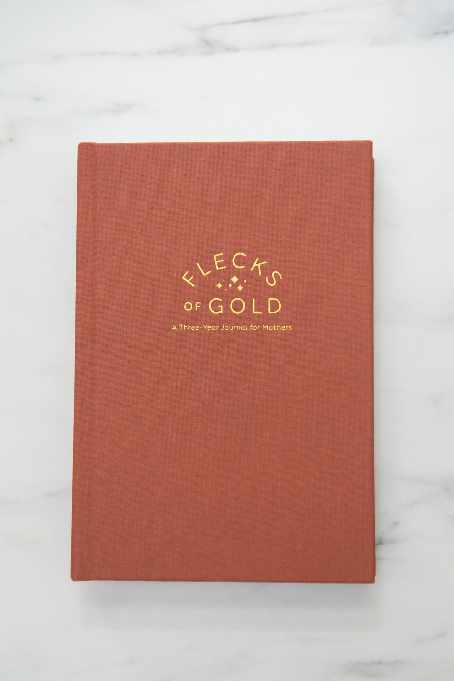Terracotta Linen Flecks of Gold Journal with gold embossing. A Three-Year Journal For Mothers. Helping you find the joy in Motherhood. A journal for moms who want to see the good in every day. Helping overwhelmed, busy moms. Created by Rachel Nielson of 3 in 30 Podcast.