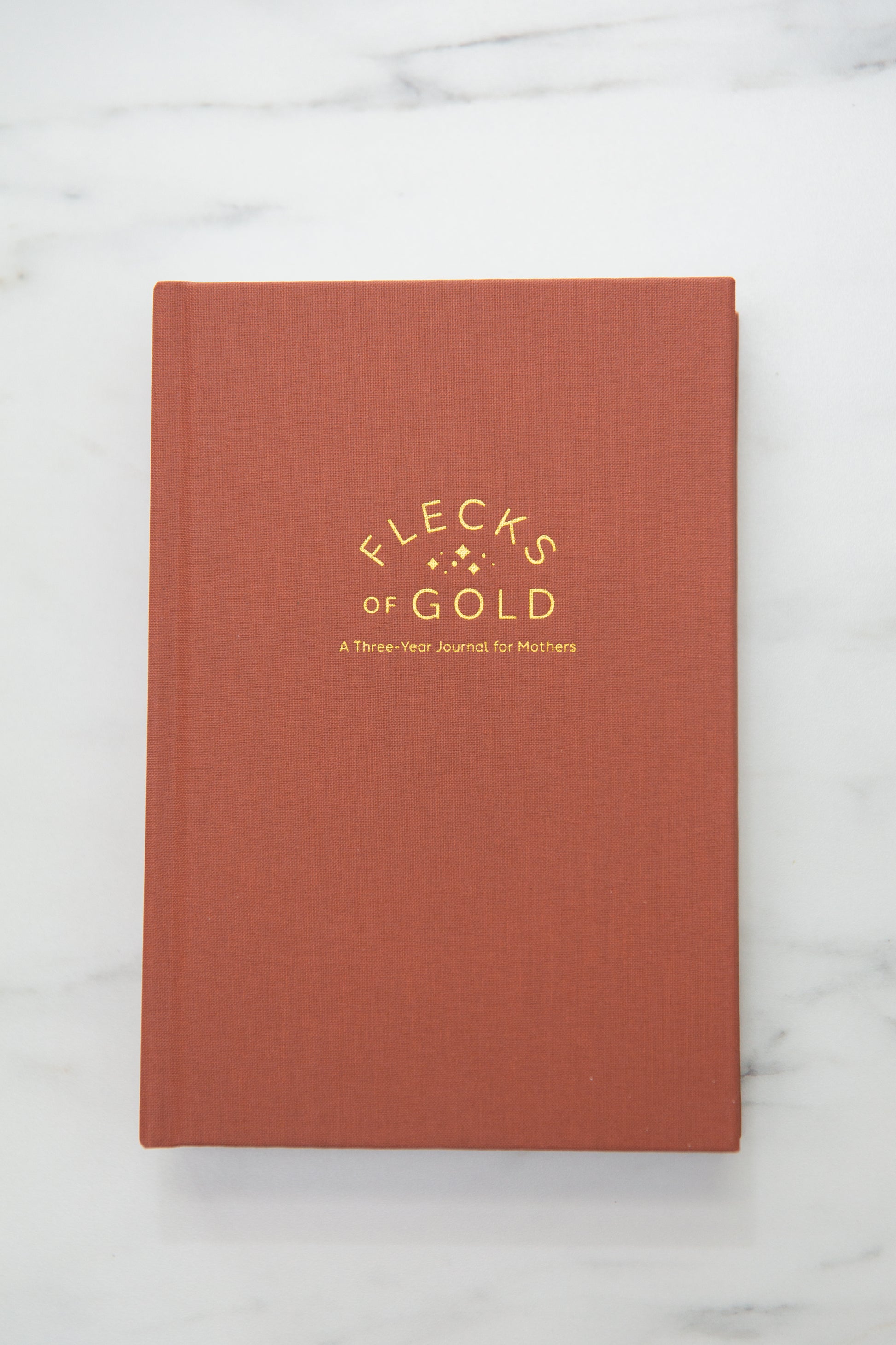 Terracotta Linen Flecks of Gold Journal with gold embossing. A Three-Year Journal For Mothers. Helping you find the joy in Motherhood. A journal for moms who want to see the good in every day. Helping overwhelmed, busy moms. Created by Rachel Nielson of 3 in 30 Podcast.