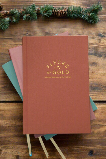 Terracotta Linen Flecks of Gold Journal with gold embossing. A Three-Year Journal For Mothers. Helping you find the joy in Motherhood. A journal for moms who want to see the good in every day. Helping overwhelmed, busy moms. Created by Rachel Nielson of 3 in 30 Podcast.