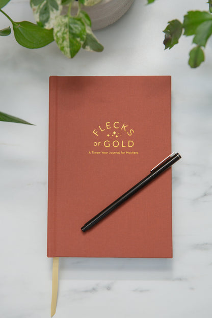 Terracotta Linen Flecks of Gold Journal with gold embossing. A Three-Year Journal For Mothers. Helping you find the joy in Motherhood. A journal for moms who want to see the good in every day. Helping overwhelmed, busy moms. Created by Rachel Nielson of 3 in 30 Podcast.