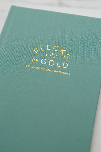 Teal Linen Flecks of Gold Journal with gold embossing. A Three-Year Journal For Mothers. Helping you find the joy in Motherhood. A journal for moms who want to see the good in every day. Helping overwhelmed, busy moms. Created by Rachel Nielson of 3 in 30 Podcast.
