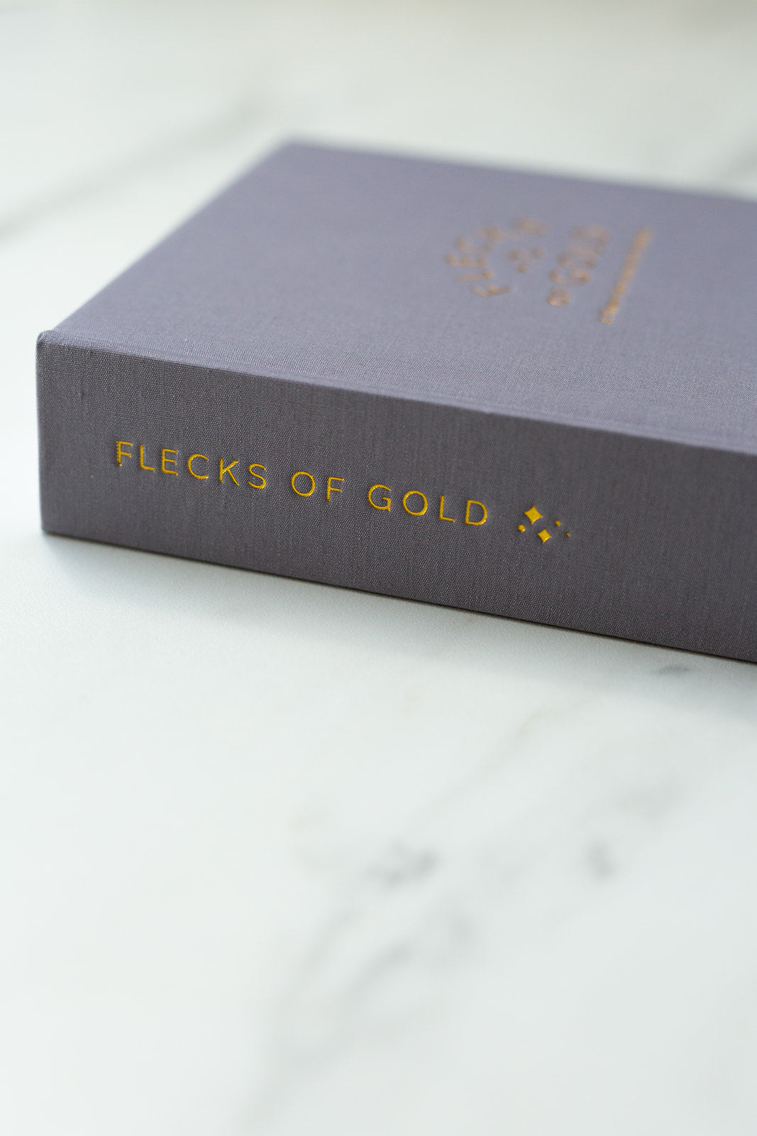 Beautiful Flecks of Gold Journal.  Motherhood journal created by Rachel Nielson (host of the 3 in 30 Takeaways for Moms Podcast).  A journal to help overwhelmed moms see the good, the magic, the gold in their everyday lives.  Gold embossing.